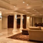 Basement remodeling in Newcastle WA featuring a luxury finished basement with columns, coffered ceiling, and elegant living space.