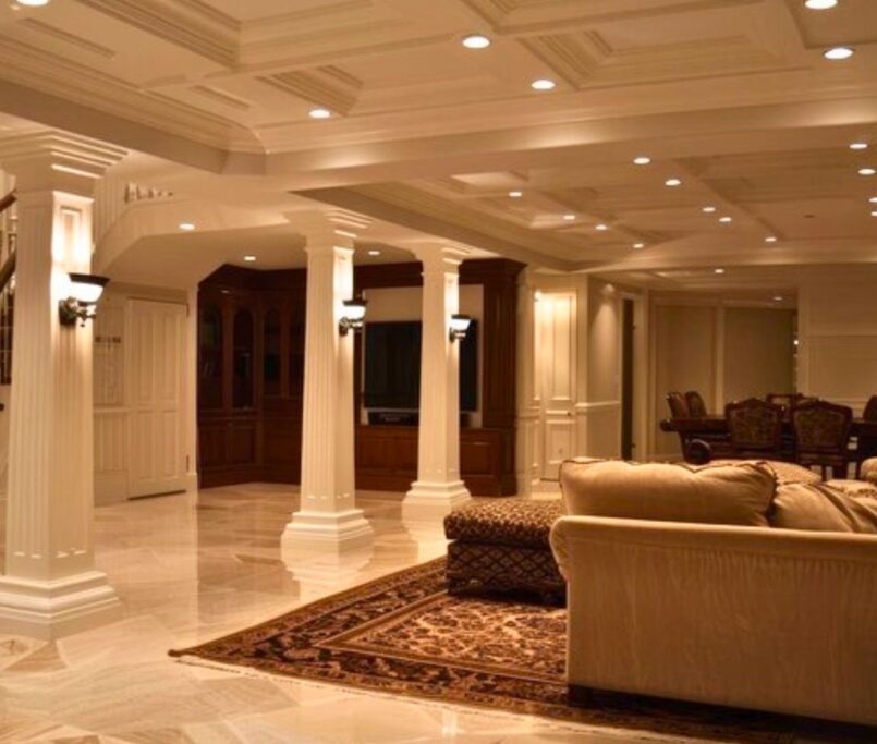 Basement remodeling in Newcastle WA featuring a luxury finished basement with columns, coffered ceiling, and elegant living space.