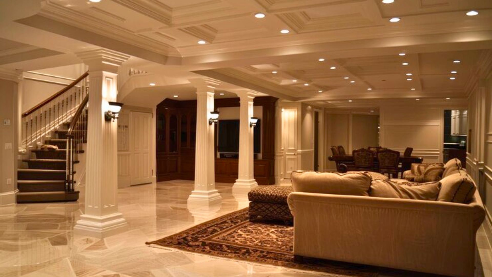 Basement remodeling in Newcastle WA featuring a luxury finished basement with columns, coffered ceiling, and elegant living space.