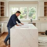 Kitchen remodel contractor in Seattle reviewing blueprints during renovation project