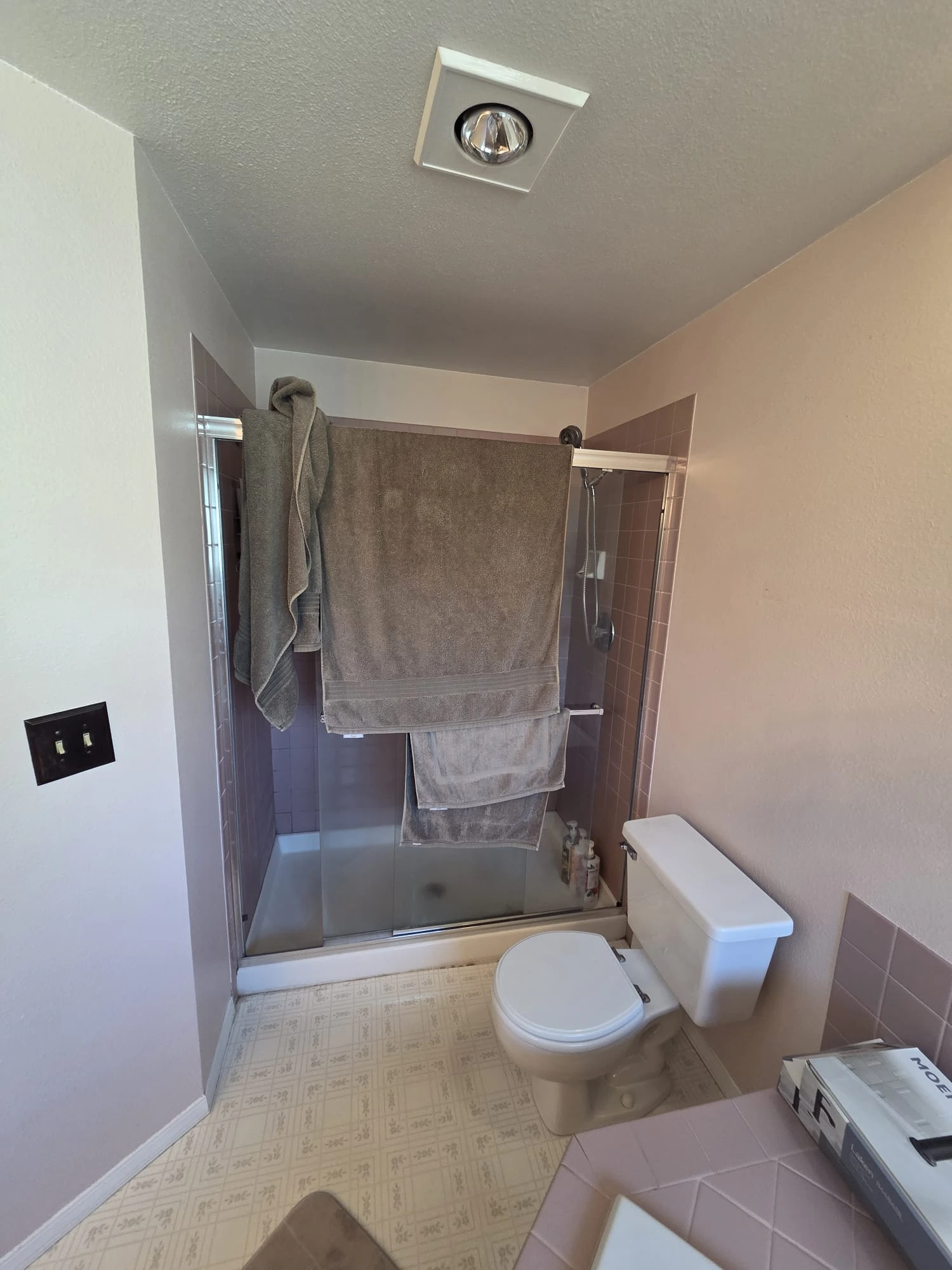Covington master bathroom shower before remodeling, with the original glass enclosure