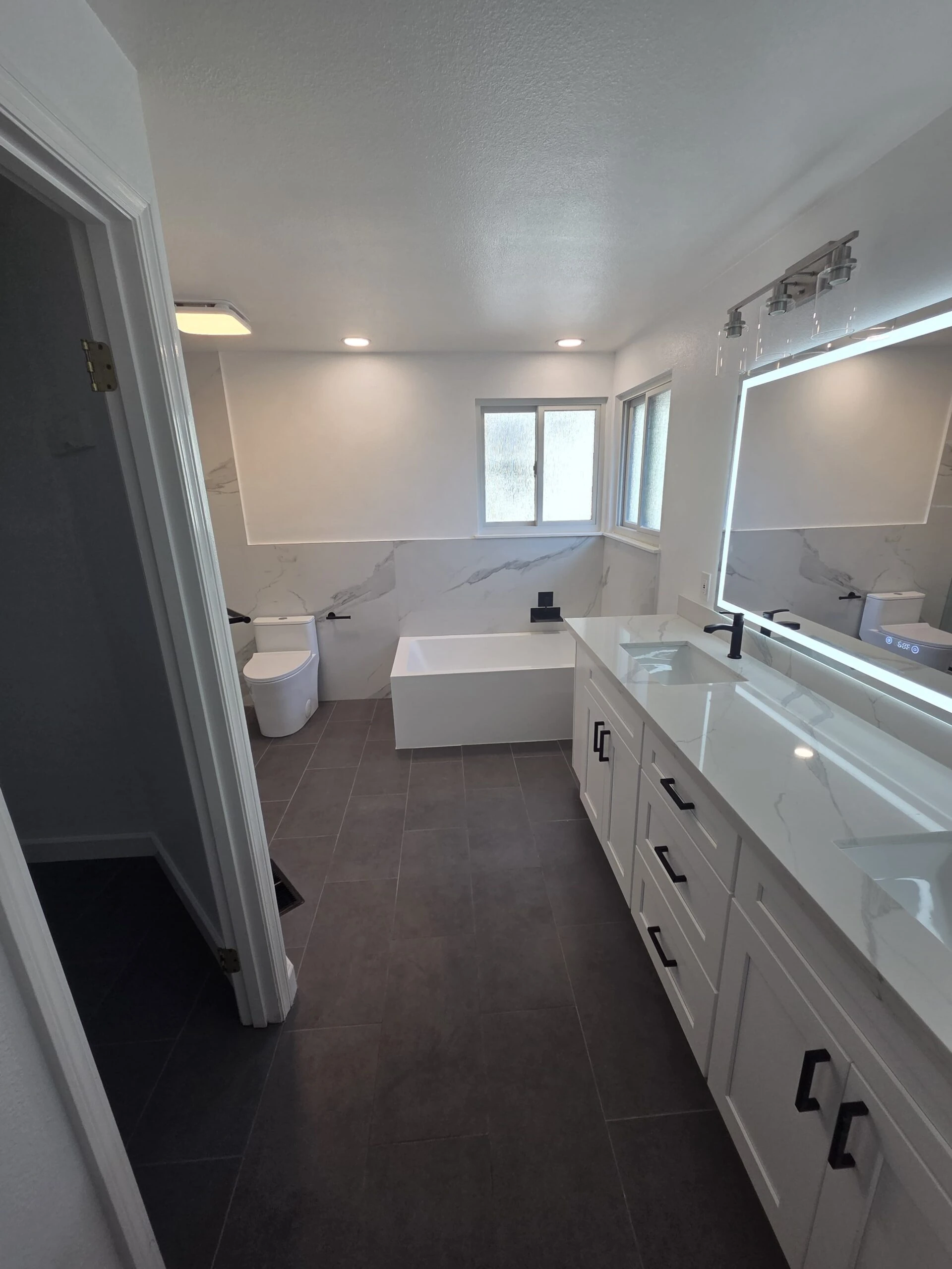 Covington master bathroom bathtub and white vanity after remodeling