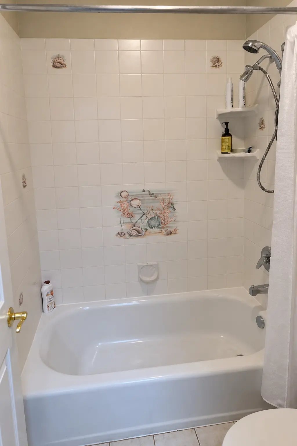 Before: dated tub and white tile shower in a Renton bathroom before a tub-to-shower conversion